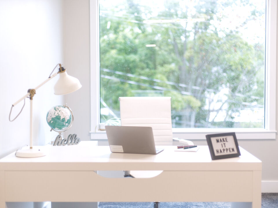A bright home desk by a window