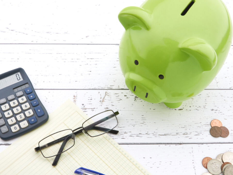 A piggy bank beside a calculator